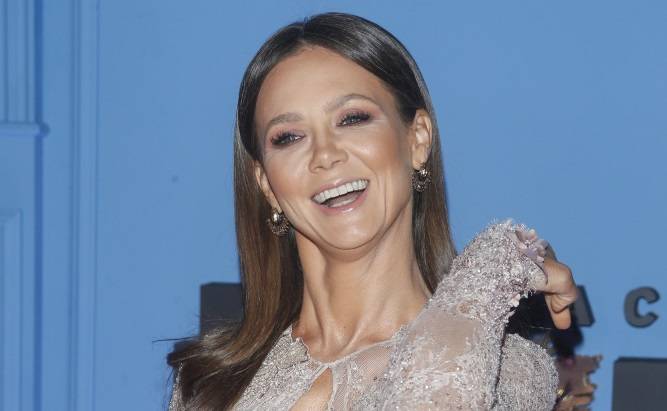 Kinga Rusin pozuje w stroju kąpielowym. Towarzyszą jej świnie